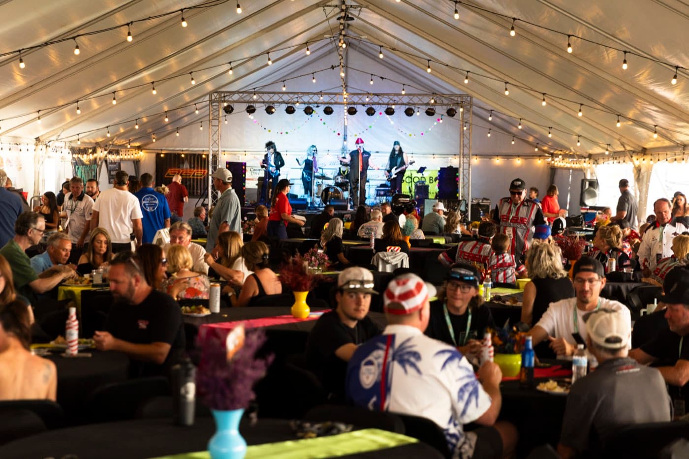 The awards tent after dark under string lights